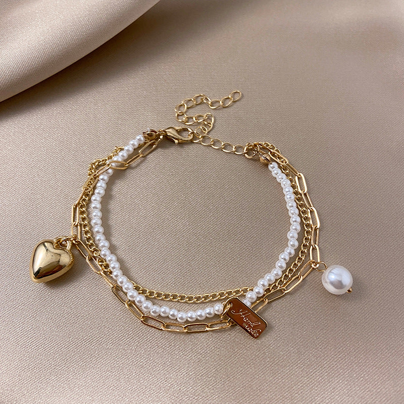 Venta al por mayor Pearl Love Heart Dreamcatcher Pulsera de aleación